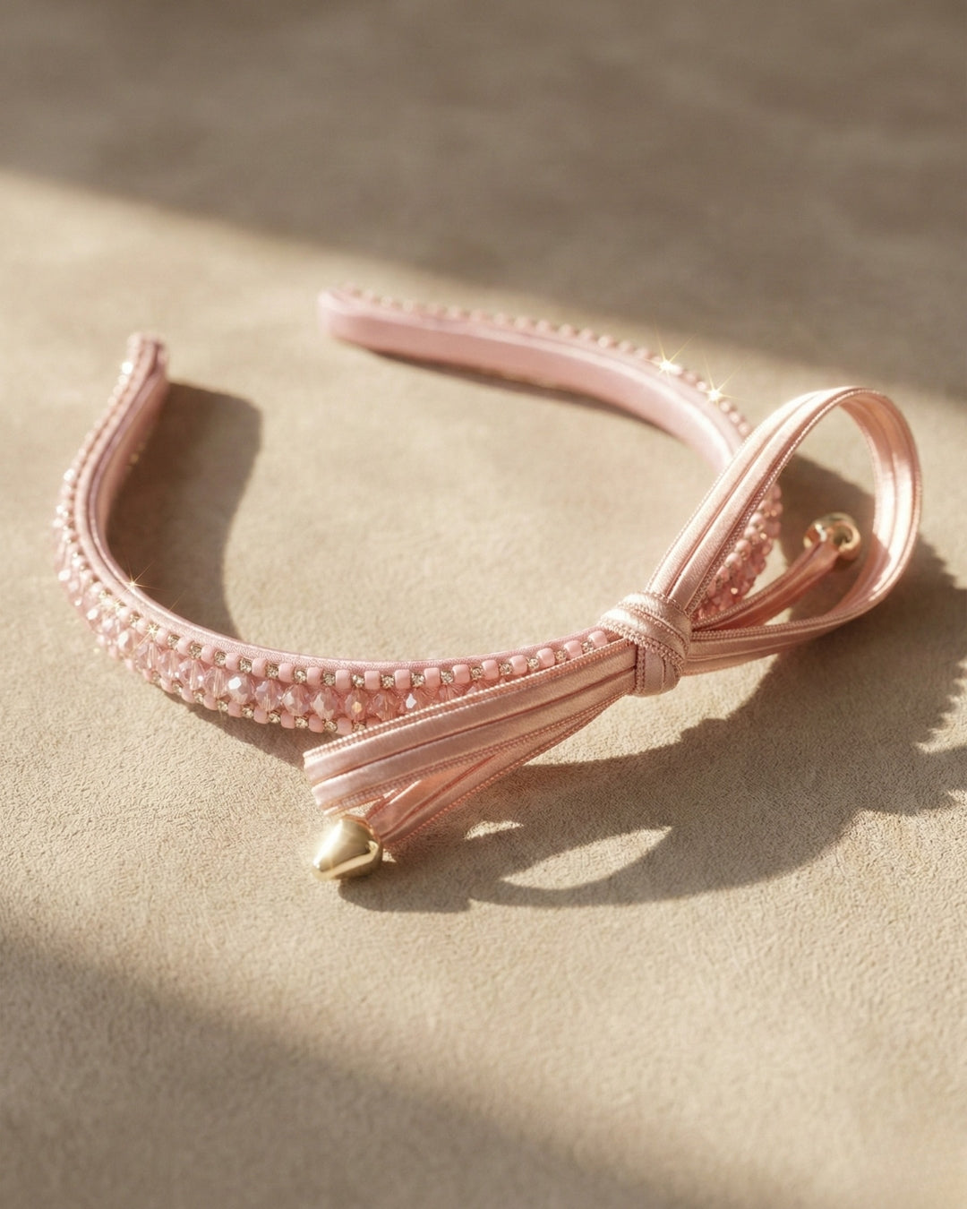 Chic Pink Twisted Bow Hairband with Sparkling Stone Embellishments