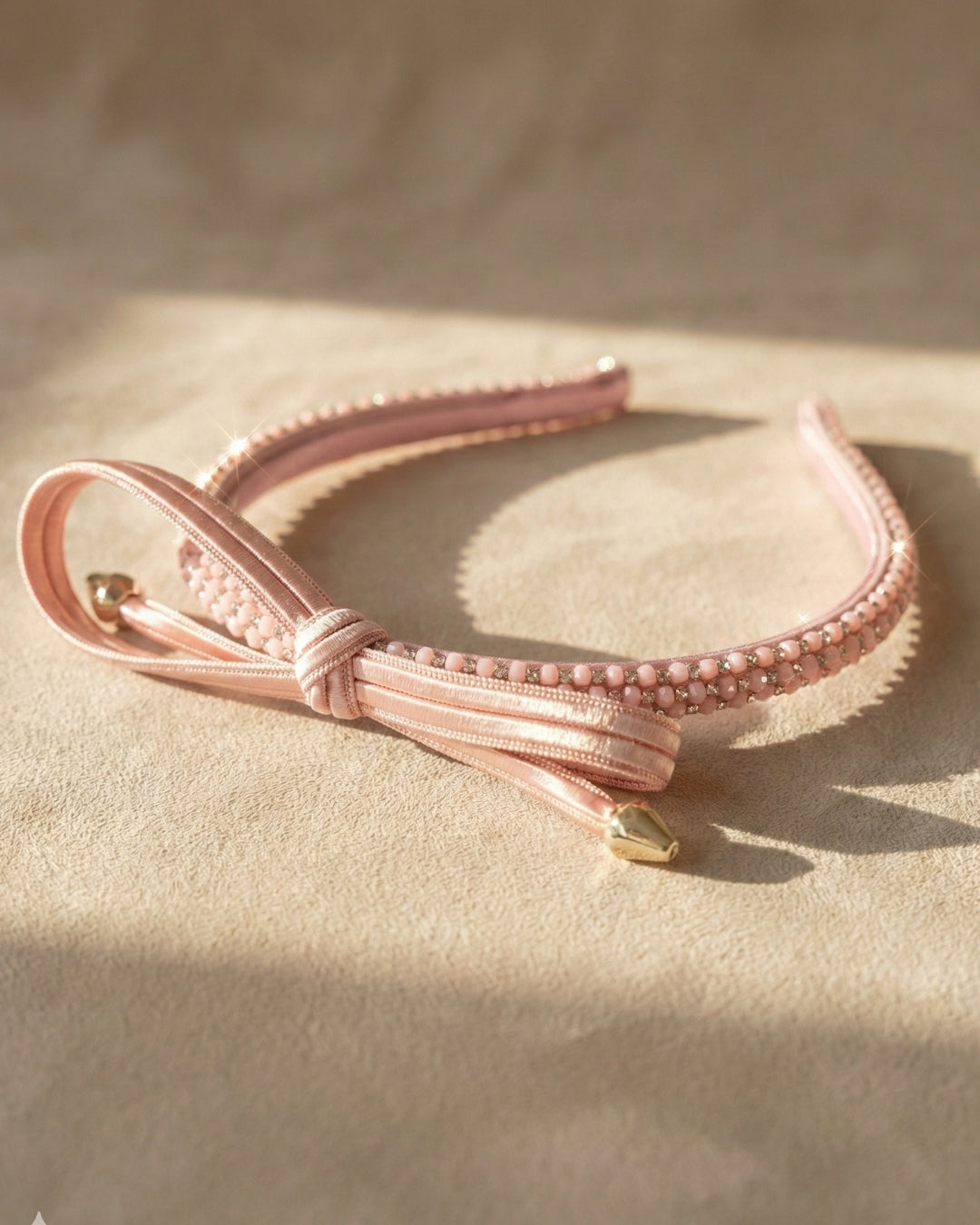 Chic Pink Twisted Bow Hairband with Sparkling Stone Embellishments